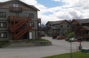 a apartment building with a staircase on the side of it at Mountain View Radium Condo - Copper Horn Village in Radium Hot Springs