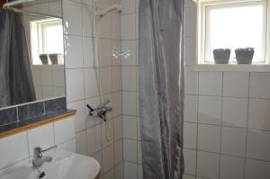 a bathroom with a shower with a sink and a mirror at Nordseter Fjellpark, Hyttegrend in Nordseter +29 photos