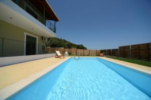 a swimming pool in the backyard of a house at Aselinos Suites in Koukounaries