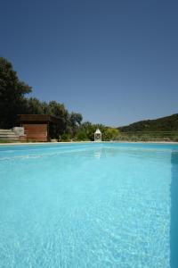 a large pool of blue water with a goal at Aselinos Suites in Koukounaries