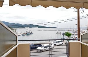 a balcony with a view of a marina with boats at Ameris Studios & Apartments in Neos Marmaras