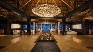 a large lobby with a large chandelier and a large room at Constance Belle Mare Plage in Belle Mare