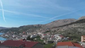 a town on a hill next to a body of water at LARA & VITO in Metajna