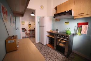 a small kitchen with a stove and a refrigerator at Sun sto Spiti in Athens +19 photos