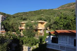 a building with a mountain in the background at Hotel Aurora in Vlorë