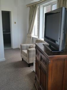a living room filled with furniture and a tv at The Bridge Hotel in Scunthorpe