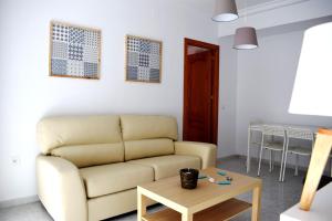 a living room with a couch and a table at El Jardin BeNerja in Nerja