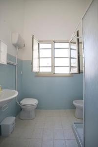 a bathroom with a toilet and a sink at Largo Madonna in Trapani