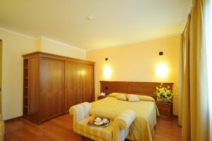 Posteľ alebo postele v izbe v ubytovaní Hotel Panoramic Montepulciano