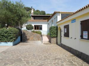 a house with a walkway next to a building at La Corte Degli Ulivi in Cardedu
