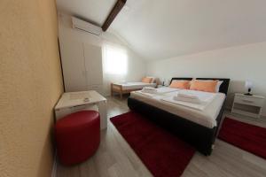 a bedroom with a large bed and a red rug at King San in Mostar