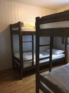 two bunk beds in a room with a bed at Skarsnuten Panorama 14 in Hemsedal