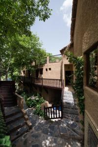 a building with stairs and a bench in a yard at Riad Oussagou in Imlil