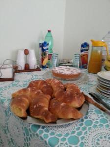 a plate of pastries and a cake on a table at B&B Stella Marina in Soverato Marina