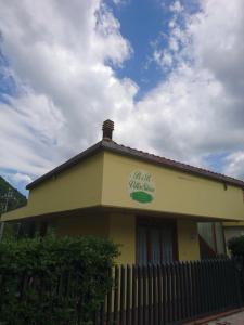 a building with a sign on the side of it at Villa Silvia in Acquasanta Terme