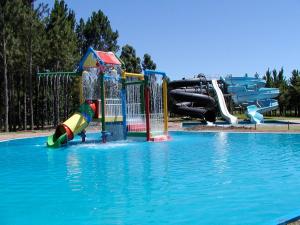 a swimming pool with a water park with slides at Gran Hotel Uruguay in Salto