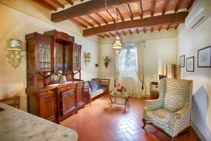 a living room with a chair and a table at Podere Sant'Antonio in Fauglia