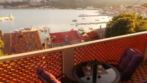 a balcony with a table and chairs and a view of a harbor at Apartments Andrea in Baška