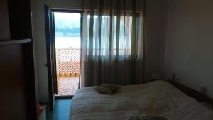 a bedroom with a bed and a window with a view at Apartments Andrea in Baška