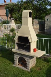 a brick oven with a cup on top of it at Apartment MIRAKUL in Senj