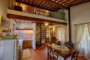 a kitchen and dining room with a loft at Podere Sant'Antonio in Fauglia
