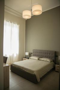 a bedroom with a large bed and a window at Al Tartarughino B&B in Cercola