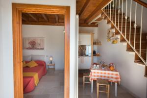 a bedroom and a living room with a bed and a table at Grandi Trulli Bed & Breakfast in Alberobello