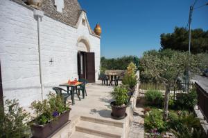 a patio with tables and chairs next to a building at Grandi Trulli Bed & Breakfast in Alberobello