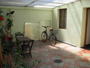 a bike parked next to a table in a courtyard at Penzion 102 in Pardubice