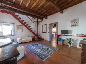 a large living room with a staircase and a living room at Mamo Florence - Vasari Apartment in Florence