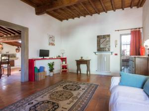 a living room with a white couch and a table at Mamo Florence - Vasari Apartment in Florence