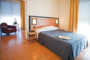 Posteľ alebo postele v izbe v ubytovaní Hotel Masini