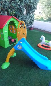 a childs play set with a slide and a toy house at Apartments Julija in Vela Luka