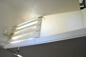 a light hanging from the ceiling of a room at Little Red Caboose in Oakhurst