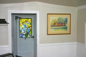 a door with a window and a picture of a train at Little Red Caboose in Oakhurst