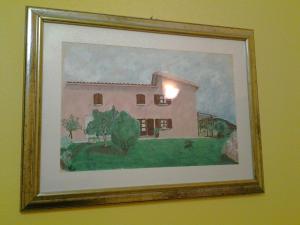 a painting of a house on a wall at Hotel Su Giudeu in Chia