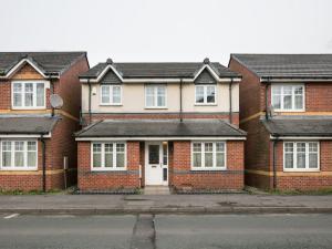 a row of brick houses on a street at My-Places Corporate Serviced Accommodation in Manchester