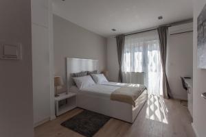 Postel nebo postele na pokoji v ubytování Priuli Suites