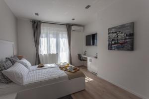 TV a/nebo společenská místnost v ubytování Priuli Suites