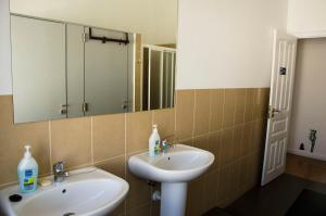 a bathroom with a sink and a mirror at White Sun Hostel in Lagos