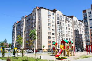 a playground in front of a large apartment building at Apartment Shakhmatnaya in Kaliningrad