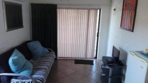 a living room with a couch and a television at 18 on Barnard in Port Elizabeth