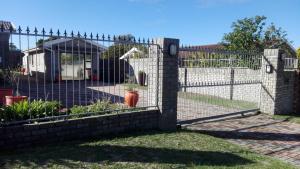 a fence in front of a garden with a playground at 18 on Barnard in Port Elizabeth