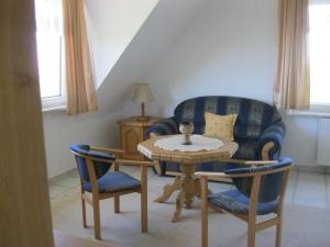 a living room with a table and a blue couch at Rezydencja Nad Jeziorem Łebsko in Łeba +40 photos