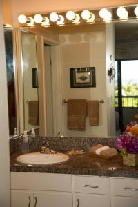 a bathroom with a sink and a large mirror at Wailea Sunset Condo - Ekolu #607 in Wailea