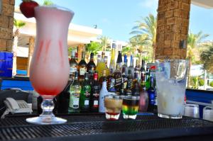 a bar with a bunch of bottles of drinks on a table at Pangea Beach Resort in Jiyeh