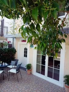 a patio with chairs and a table and a tree at Holiday Home Dunja in Opatija
