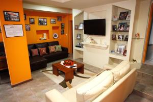 a living room with a couch and a tv at AzoresDream in Velas