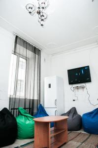 a room with bean bags and a table and a tv at Galactic Globus in Kyiv