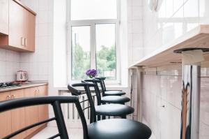 a row of chairs sitting in a kitchen at Galactic Globus in Kyiv